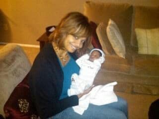 Carla holding her infant son