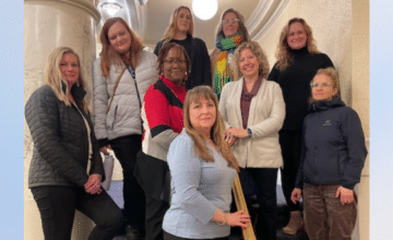 A group of mixed women standing on stairsteps