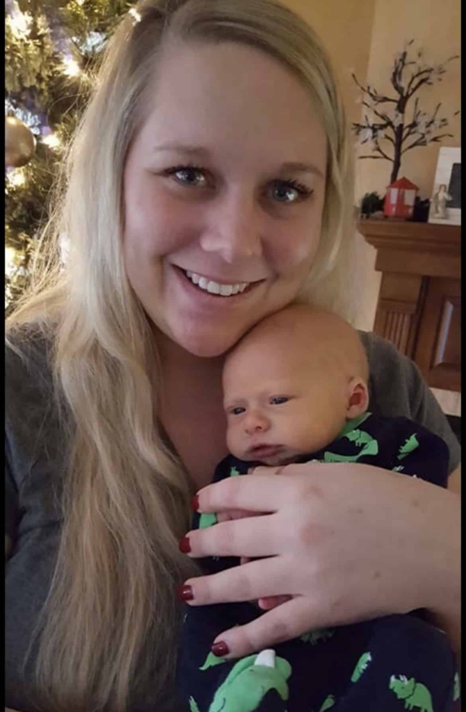 a woman holding a small infant