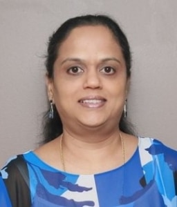 a woman with long dark hair wearing a multi-blue shaded and white top