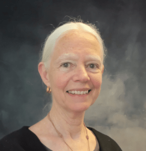 a woman with white hair wearing a black shirt