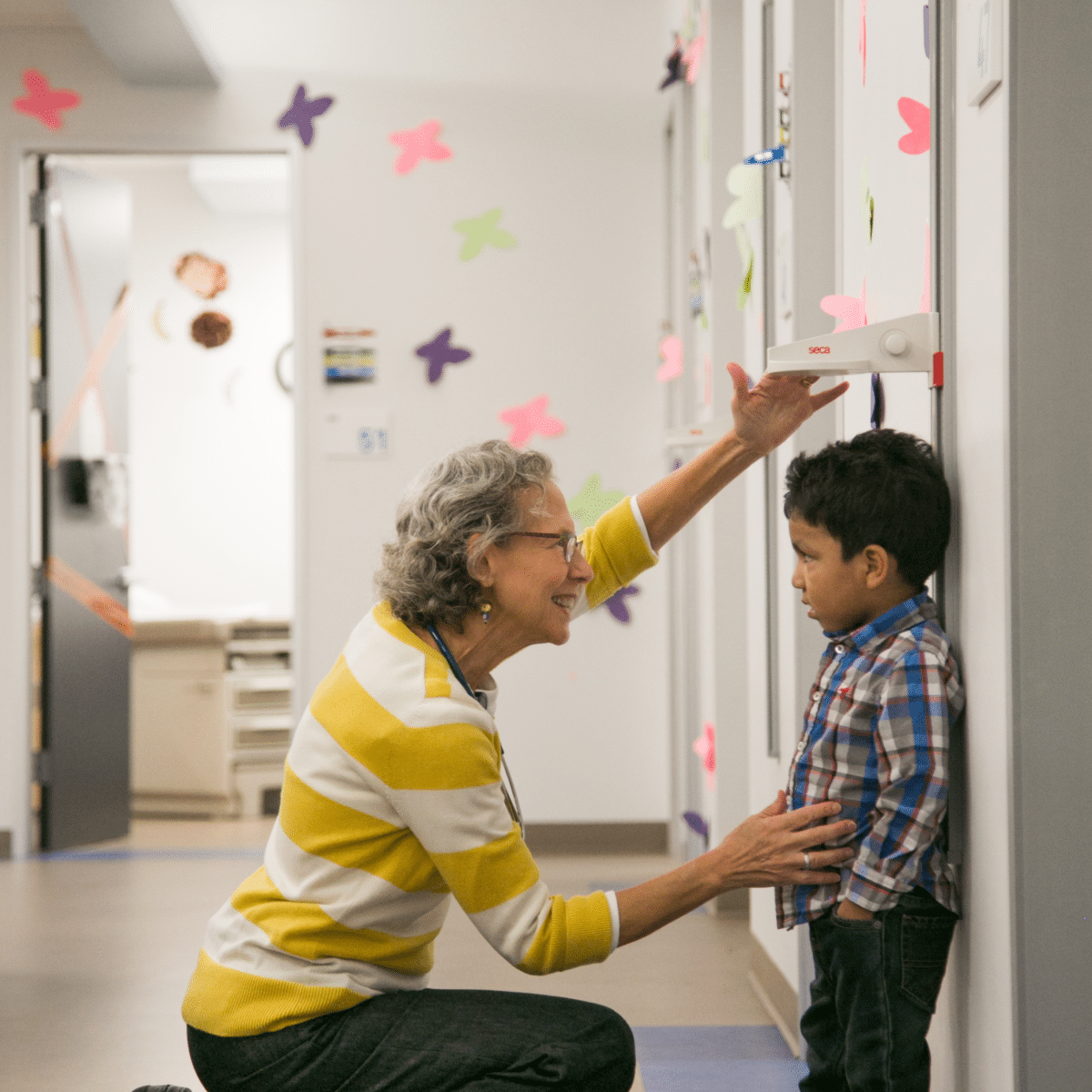 doctor checking child's height