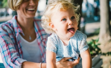 Toddler girl smiling with her mother