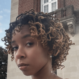 a woman with short dark curly hair