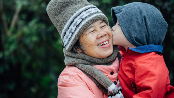 child kisses woman