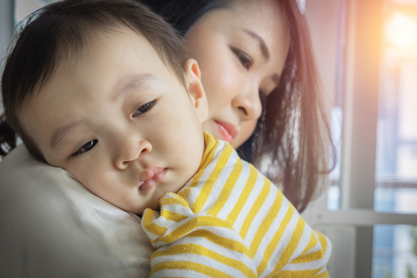 An,Asian,Boy,Was,Crying,With,Sad,Face,Expression,,Being sad baby being held by mom