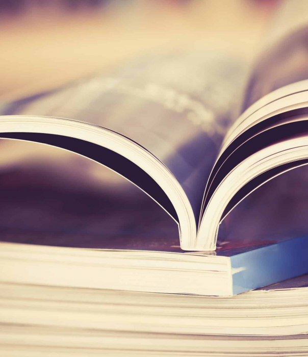 A book is opened with the pages visible from the side
