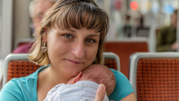 mom on bus with newborn